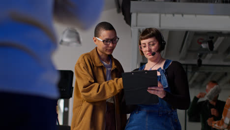 Female-Film-Director-And-Assistant-Watching-Actors-And-Checking-Script-Shooting-Movie-Or-Video-Scene-In-Studio-3